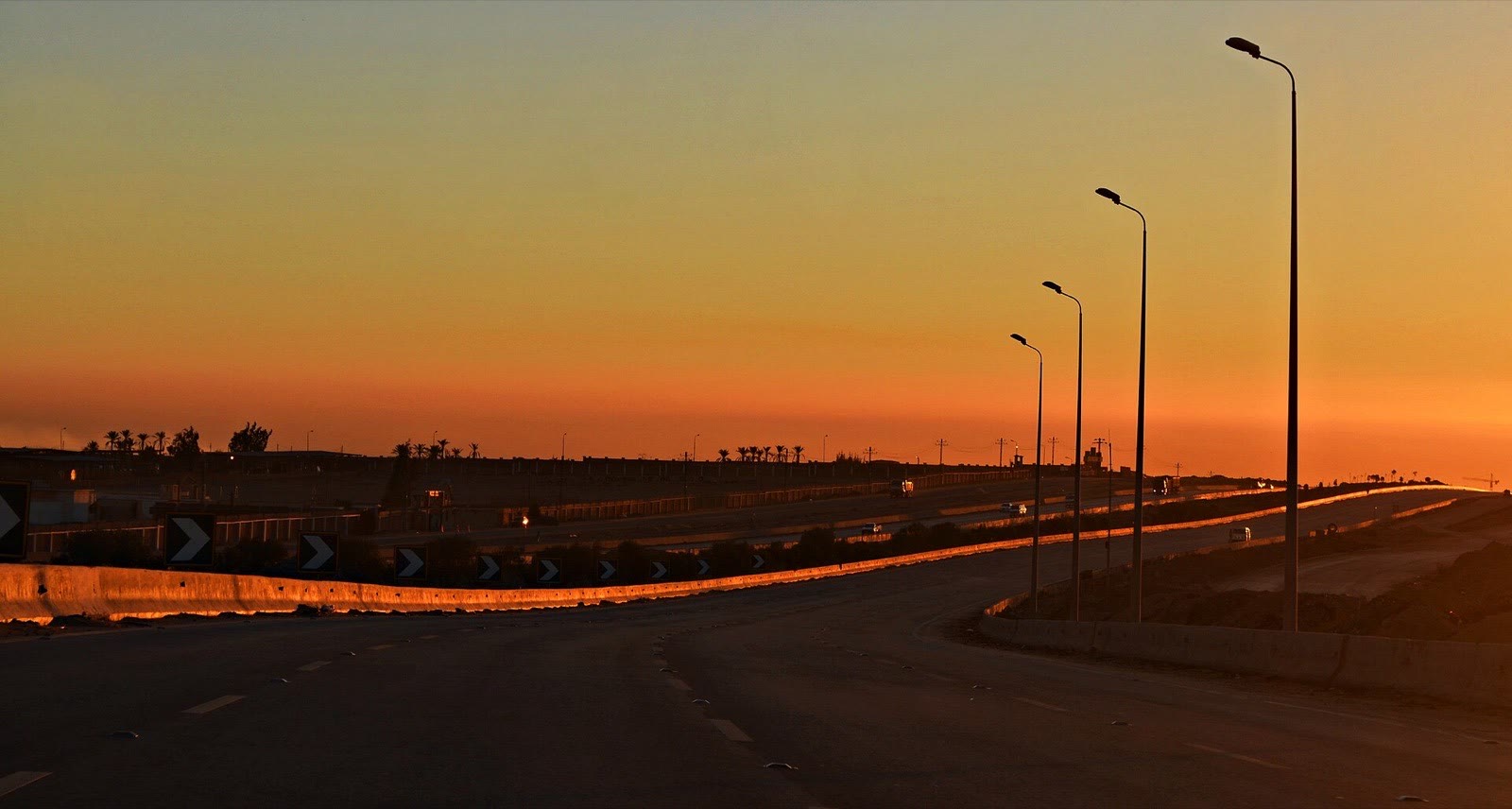 Warm sunrise light over the Cairo–Alexandria desert road
